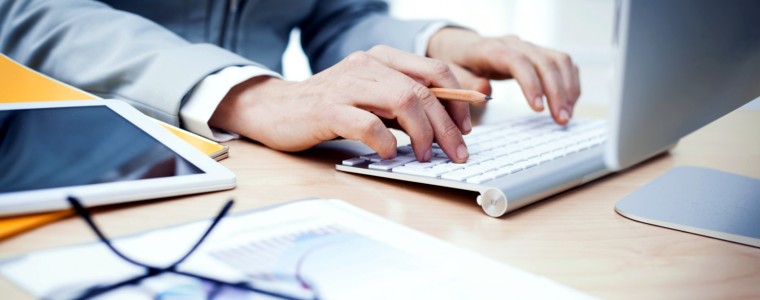 Professional using a computer and reading important information.